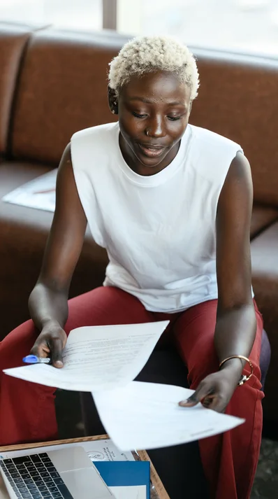 Black businesswoman reviewing documents at a desk